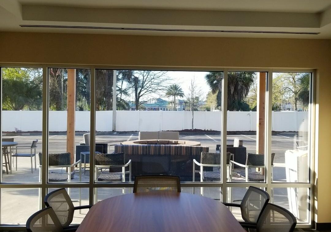 A hotel's conference room looking out large windows to a fire pit area